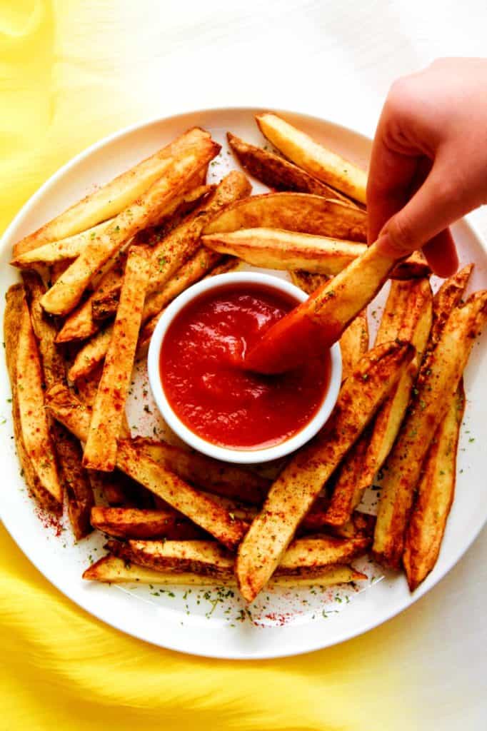 Homemade tomato ketchup from fresh tomatoes served with crispy oven-baked fries
