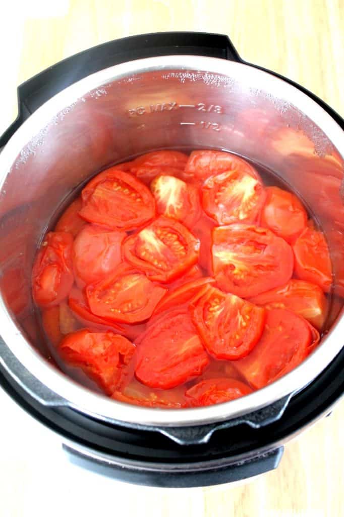 Fresh tomatoes pressure cooking in Instant Pot for homemade ketchup