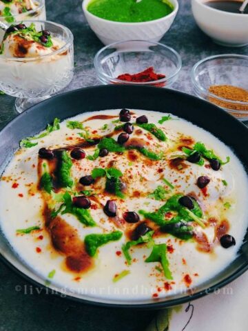 Plate of homemade dahi vada with yogurt and chutneys
