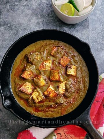 Palak paneer with soft paneer cubes in bright green spinach gravy served with roti