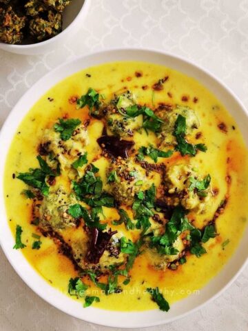Methi pakora kadhi with fenugreek fritters simmered in tangy yogurt besan sauce over basmati rice