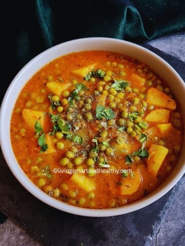 Instant Pot Aloo Matar curry served in a bowl with potatoes and green peas