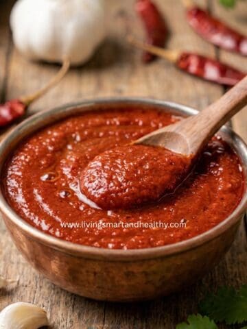1. Homemade red chutney served in a bowl, an easy garlic chutney for dabeli, vada pav, and Indian chaats.
